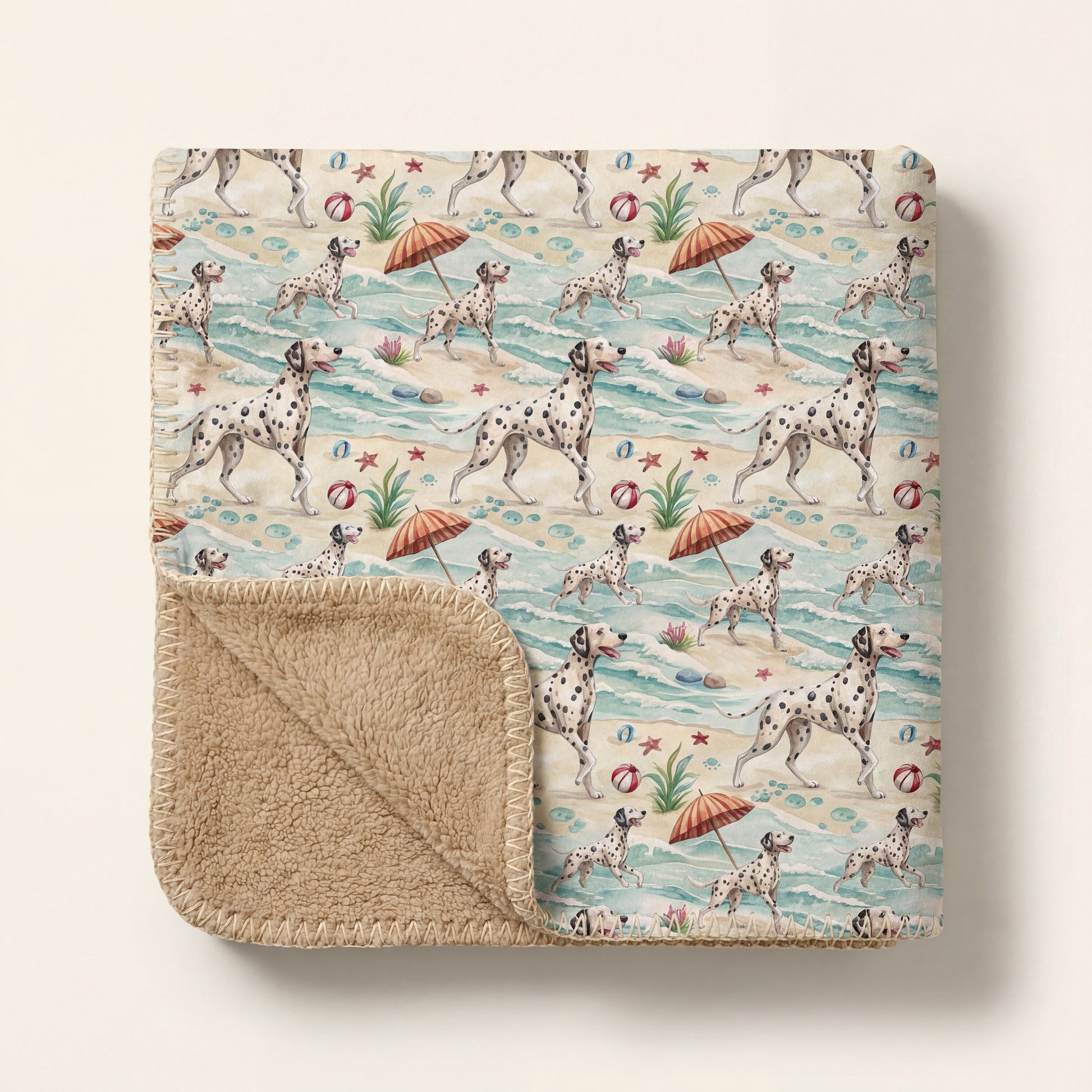 Top-down product photo of the Dalmatian Beach Day Sherpa Blanket, folded with one corner turned back to reveal the plush sherpa lining
