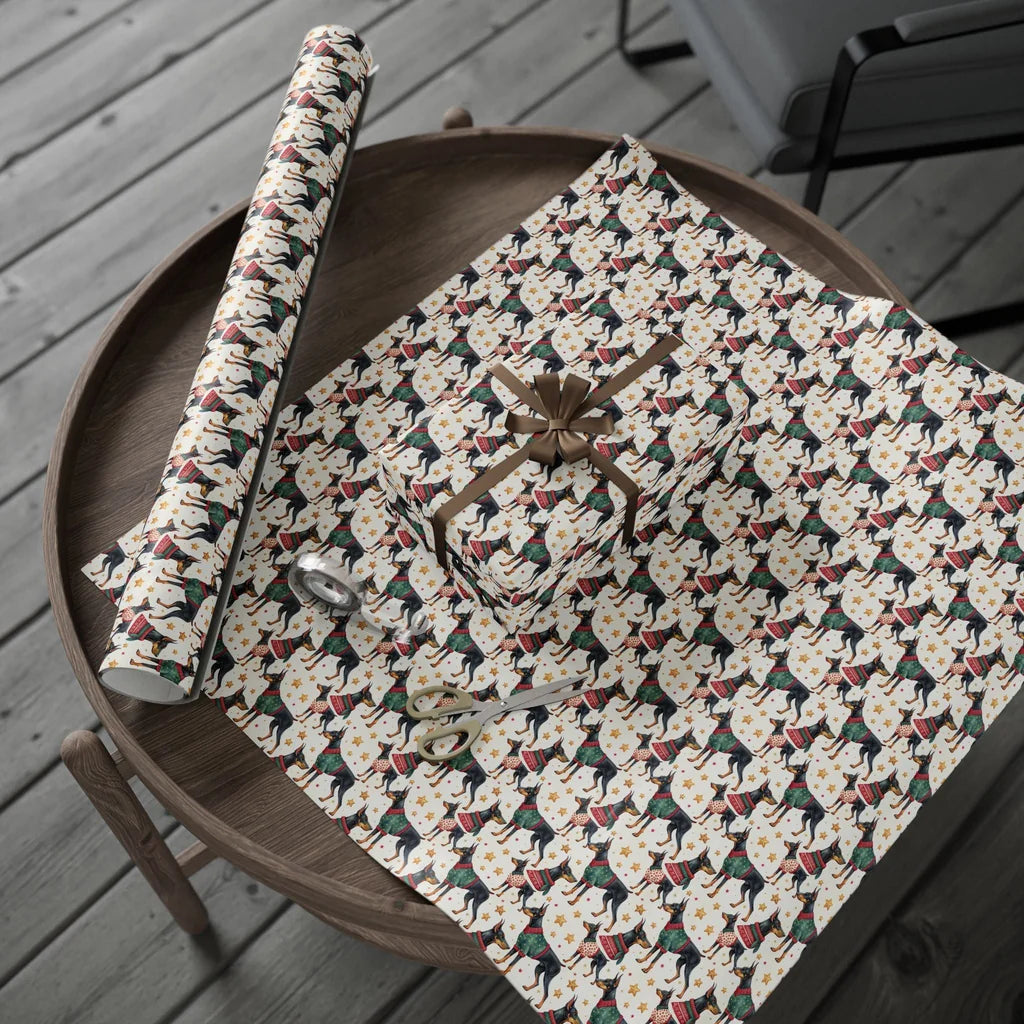Festive Doberman Christmas Wrapping Paper — gift wrapping presented on a wooden table