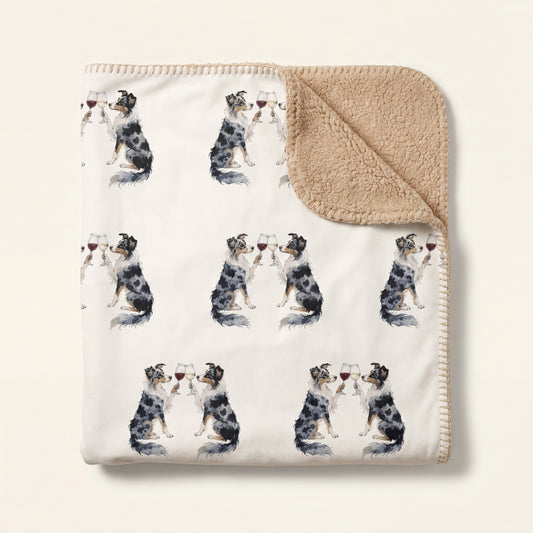 Top-down product photo of the Happy Hour Australian Shepherd sherpa blanket folded on a cream background