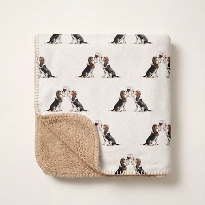 Top-down product photo of the Happy Hour Basset Hound sherpa blanket folded on a cream background