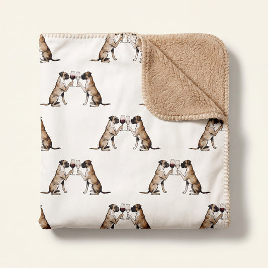 Top-down product photo of the Happy Hour Boxer sherpa blanket folded on a cream background