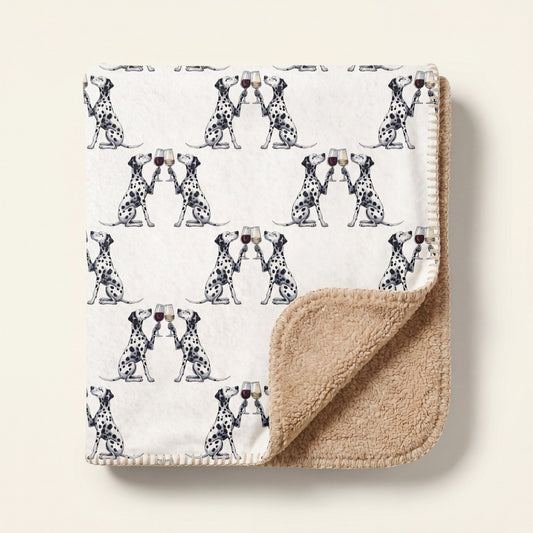 Top-down product photo of the Happy Hour Dalmatian sherpa blanket folded on a cream background