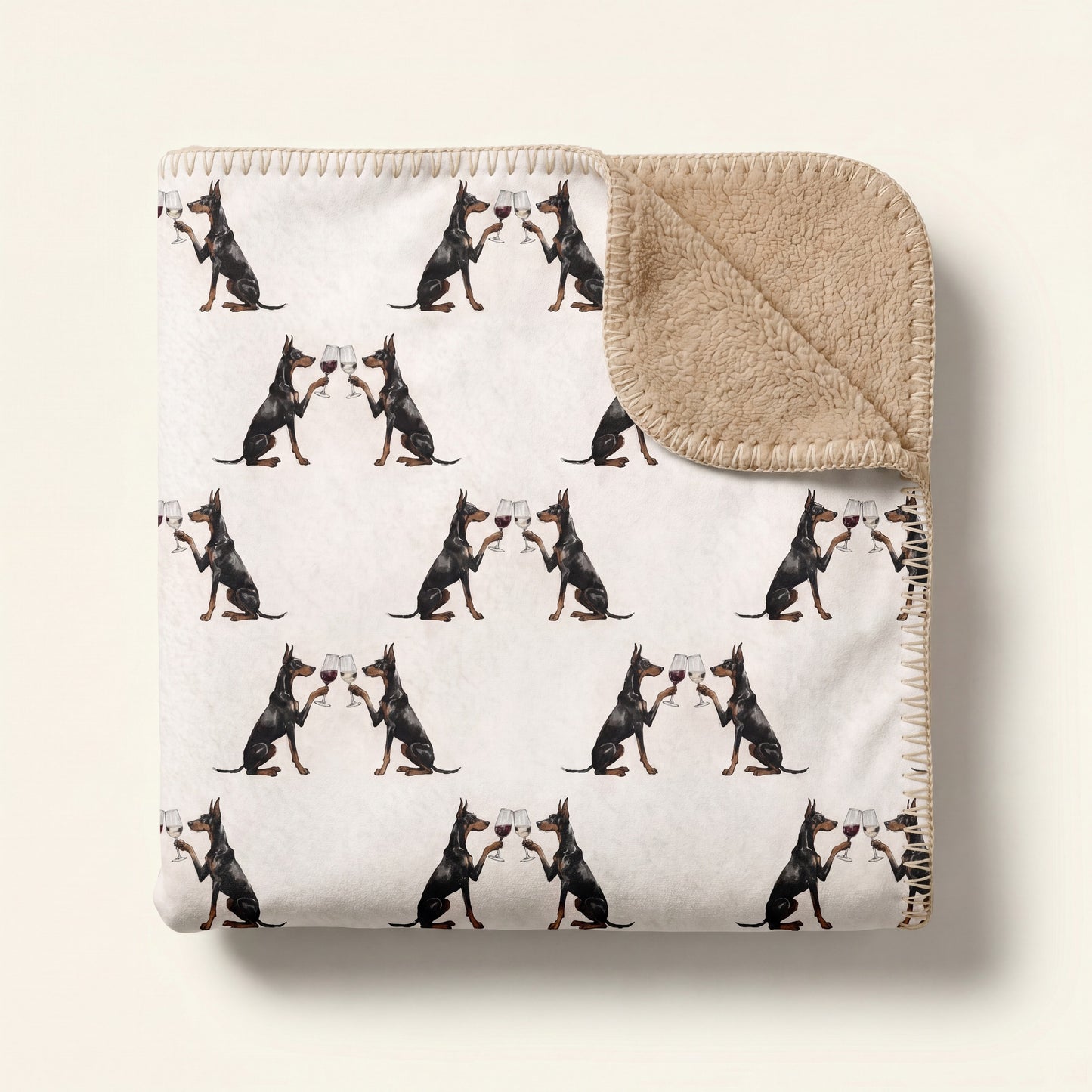Top-down product photo of the Happy Hour Doberman sherpa blanket folded on a cream background