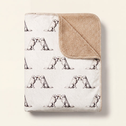 Top-down product photo of the Happy Hour Great Pyrenees sherpa blanket folded on a cream background