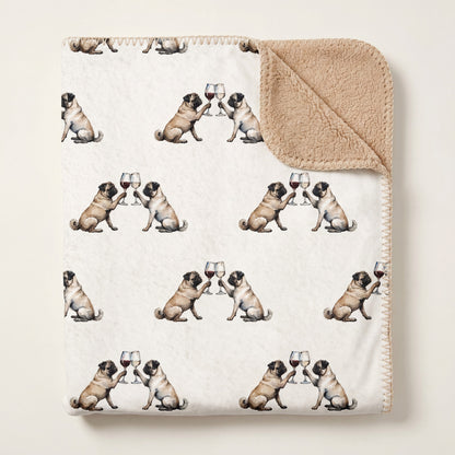 Top-down product photo of the Happy Hour Pug sherpa blanket folded on a cream background
