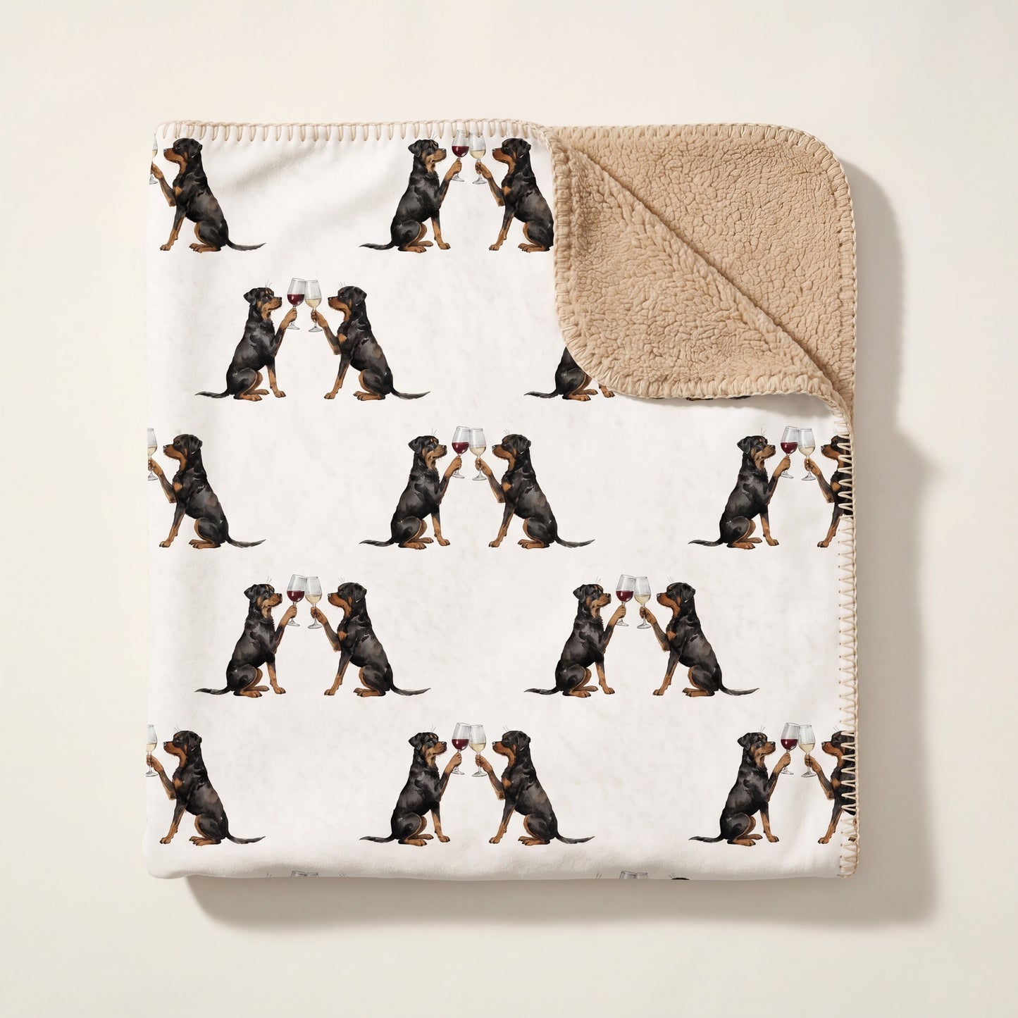 Top-down product photo of the Happy Hour Rottweiler sherpa blanket folded on a cream background