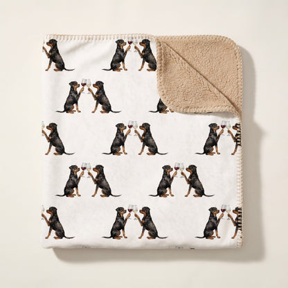 Top-down product photo of the Happy Hour Rottweiler sherpa blanket folded on a cream background