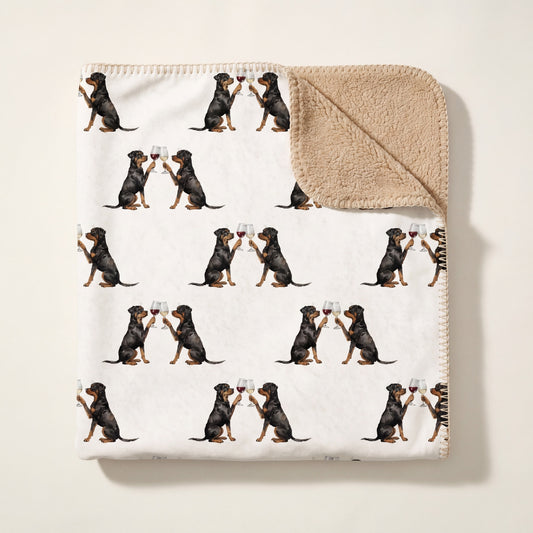Top-down product photo of the Happy Hour Rottweiler sherpa blanket folded on a cream background
