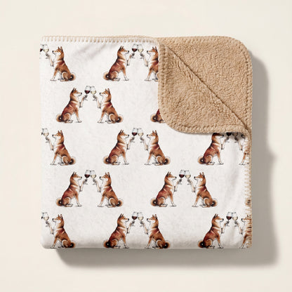 Top-down product photo of the Happy Hour Shiba Inu sherpa blanket folded on a cream background