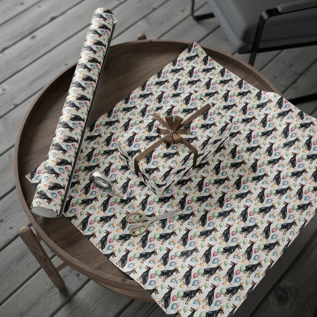 Party Pinscher: Doberman Birthday Wrapping Paper — gift wrapping presented on a wooden table