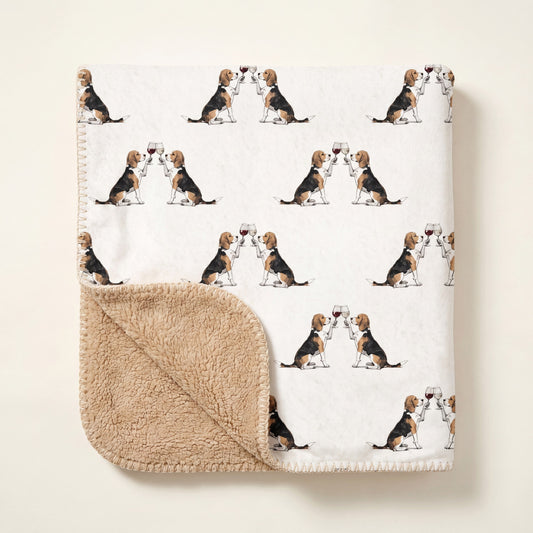 Top-down product photo of the Happy Hour Beagle sherpa blanket folded on a cream background