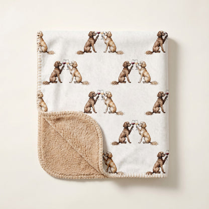 Top-down product photo of the Happy Hour Cavapoo sherpa blanket folded on a cream background