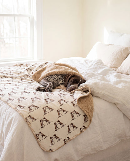 German Shorthaired Pointer curled asleep in a Happy Hour German Shorthaired Pointer sherpa blanket on a bed